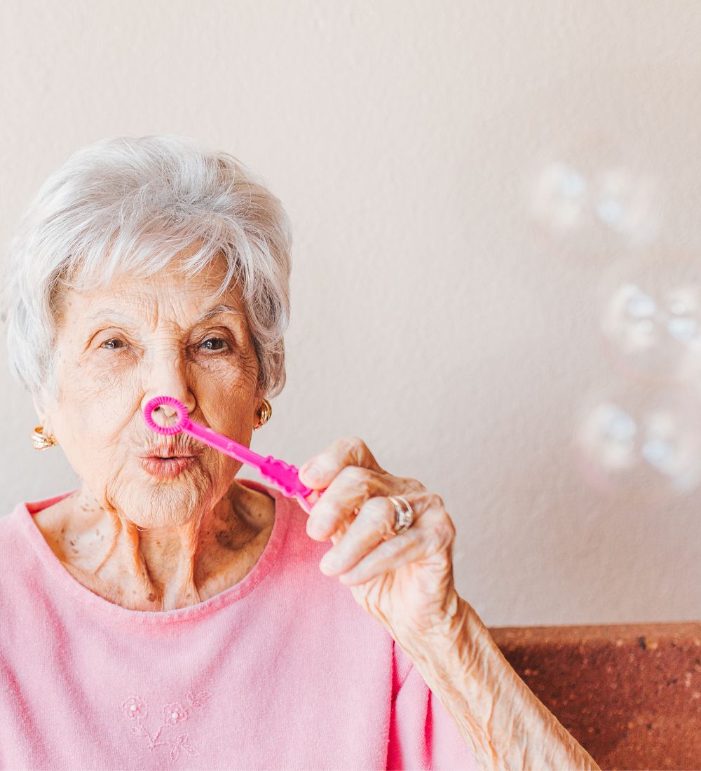 lady blowing bubbles at assisted living image